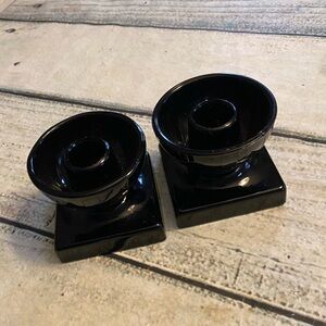 2 black glass candlesticks.